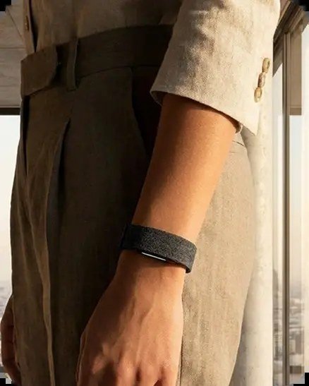 Hume Watch worn on the wrist beneath a linen sleeve — metabolic capacity tracking during everyday life